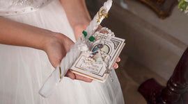 Person holding a small, ornate book with decorative elements