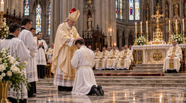 Catholic bishop laying hands on a candidate during priestly ordination