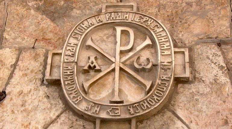 Chi Rho symbol engraved in stone wall