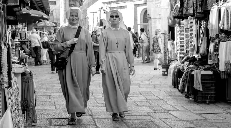 Balck and white photo of nuns walking in Old city Jerusalem