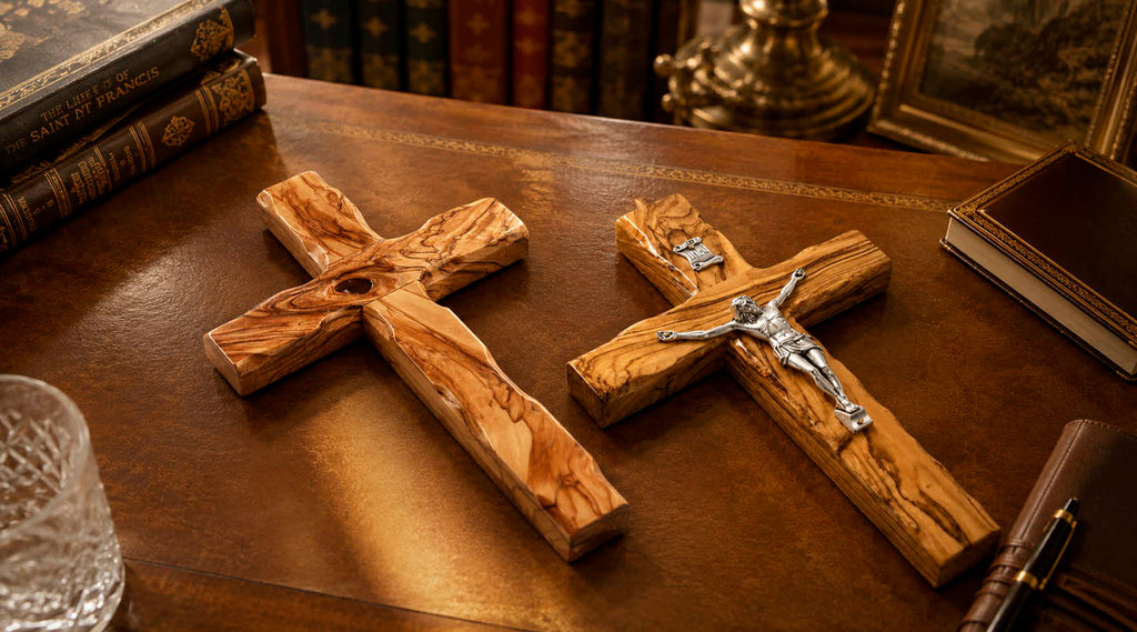 Olive wood cross and crucifix from the Holy Land displayed on a wooden desk with books in a classic study.
