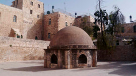 Deir Al-Sultan cupola on a sunny day with blue sky above.