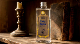 A clear bottle labeled 'Holy Water' stands on a rustic wooden shelf between old books.