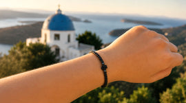 Hand showing Komboskini with a Greek Church in the background