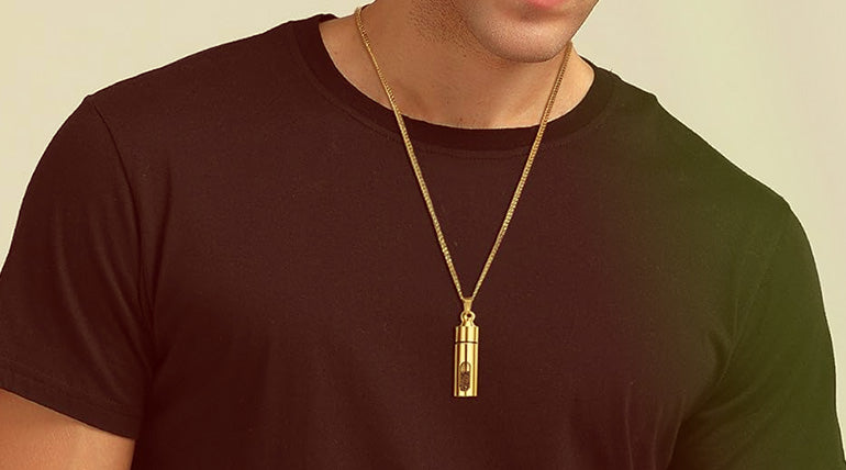 Man in a black shirt wearing a golden Christian Necklace with Holy Soil pendant