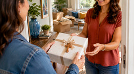 Woman receiving a wrapped Christian gift with an olive wood cross, perfect for housewarming or faith-filled occasions.