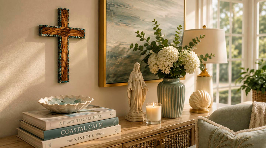 A styled interior scene with a wooden wall cross on a wall above a console table with flowers and books.
