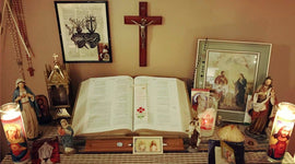 Religious items including a Bible, candles, and religious statues on a table.