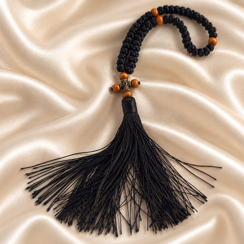 Detailed view of a black 50-knot Chotki prayer rope with wooden bead accents