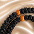 Close view of black 50-knot Chotki with wooden beads and bronze-tone cross