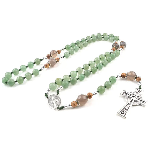 Handmade green Aventurine and Jade rosary with silver Celtic cross on white background.