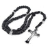 Handmade men's rosary with black paracord and durable acrylic beads, placed on white surface.