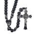 Handmade matte black 12mm acrylic bead with paracord rosary and St. Benedict crucifix on white background.
