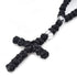 Zoom on the cross of handmade black Chotki with traditional Orthodox prayer knots.