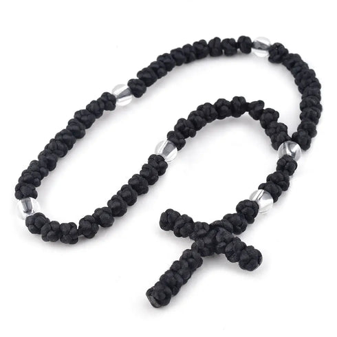 Tightly knotted black Orthodox Chotki prayer rope on white background.