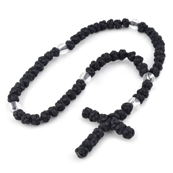 Tightly knotted black Orthodox Chotki prayer rope on white background.