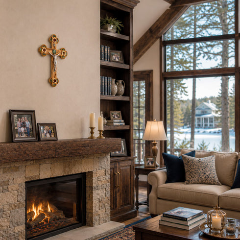 Cozy living room with stone fireplace, bookshelf, and large windows overlooking a lake.