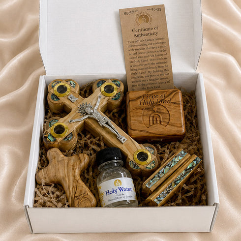 Catholic prayer gift set contents in open box: wooden cross, holy water, rosary, certificate