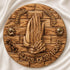 Olive wood blessing plate to hang on a wall with 'God Bless Our Home' inscription, praying hands and Holy Soil shown in detail.
