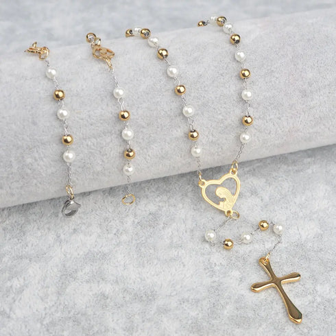 Gold-plated heart-engraved rosary with white pearl beads, designed for women, shown on a grey background.