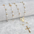 Gold-plated heart-engraved rosary with white pearl beads, designed for women, shown on a grey background.