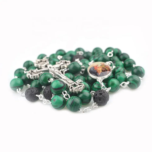 Holy Family Malachite rosary with lava stone accents, iron crucifix, laid on white background.