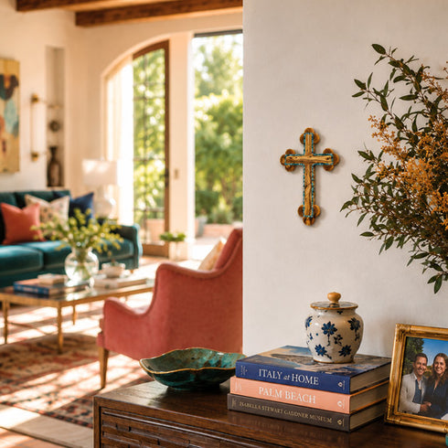 Living room with a cross on the wall, books, and decorative items.