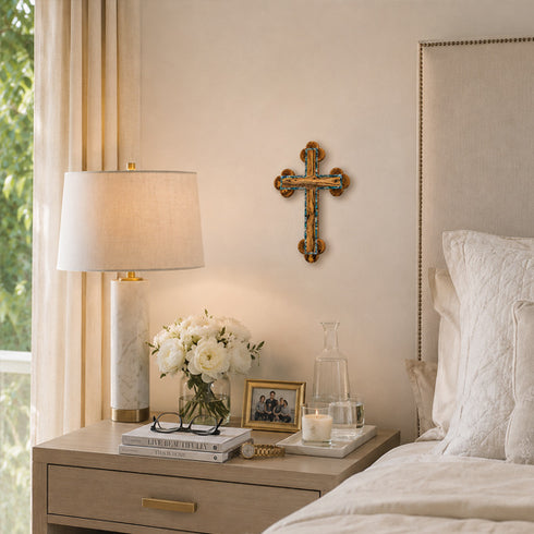 Neatly arranged nightstand with lamp, flowers, and books in a bedroom setting.