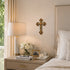 Neatly arranged nightstand with lamp, flowers, and books in a bedroom setting.