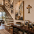 Staircase with a wall of framed pictures and a console table with books and decor.