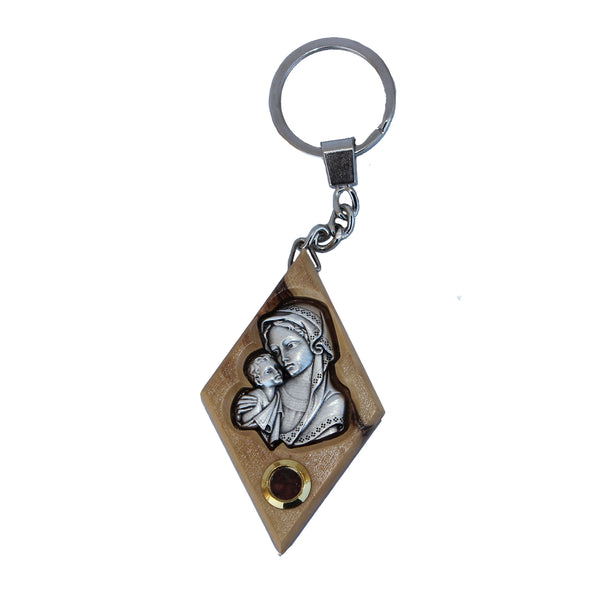 Olive wood keychain with metal emblem of Mary and Baby Jesus, featuring a capsule of Holy Soil from the Holy Land, displayed on a white background.