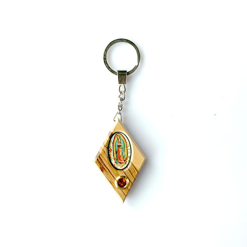 Olive wood keychain featuring a printed image of the Virgin Mary and a capsule of Holy Soil from the Holy Land, set against a white background.