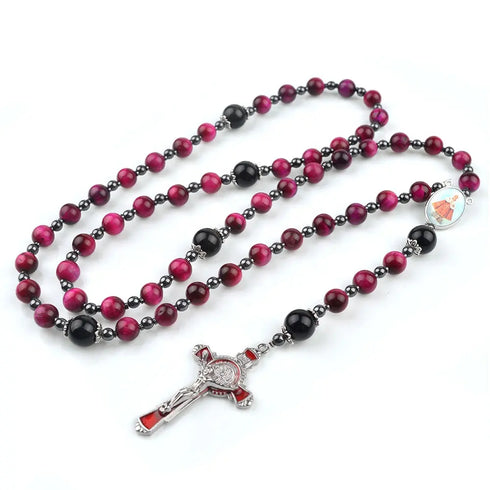 Red Tiger Eye rosary with Child Jesus emblem centrepiece and red crucifix, shot on white background.