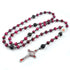 Red Tiger Eye rosary with Child Jesus emblem centrepiece and red crucifix, shot on white background.