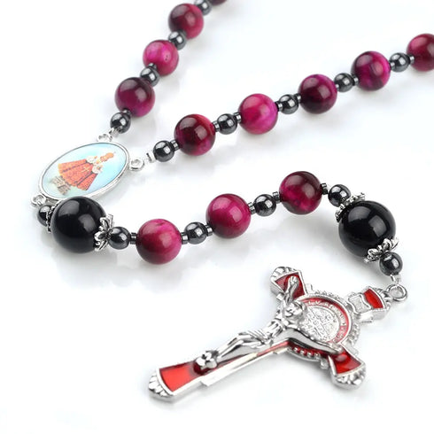 Red Tiger Eye rosary with Divine Protection theme and Child Jesus emblem centrepiece, displayed on white background.