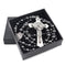 Saint Benedict rosary with dark hematite beads and silver crucifix in a black box, laid on white surface.