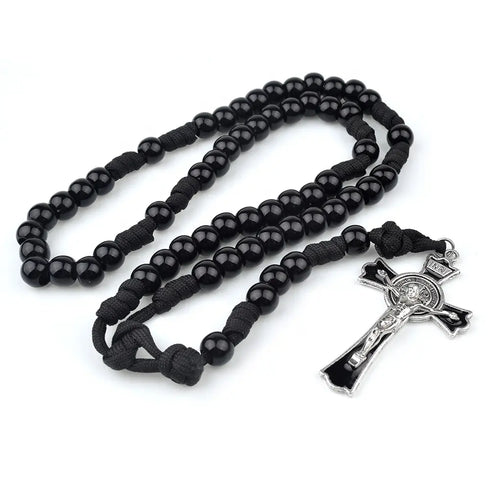 Durable black paracord rosary with shiny black 12mm beads and Benedict crucifix, laid on white background.