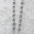 4mm stainless steel rosary beads, laid on grey background.