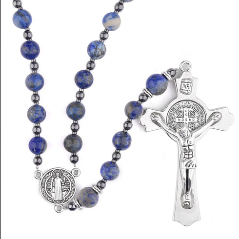 Handmade St. Benedict centrepiece rosary, lapis lazuli beads and silver crucifix, on white surface.