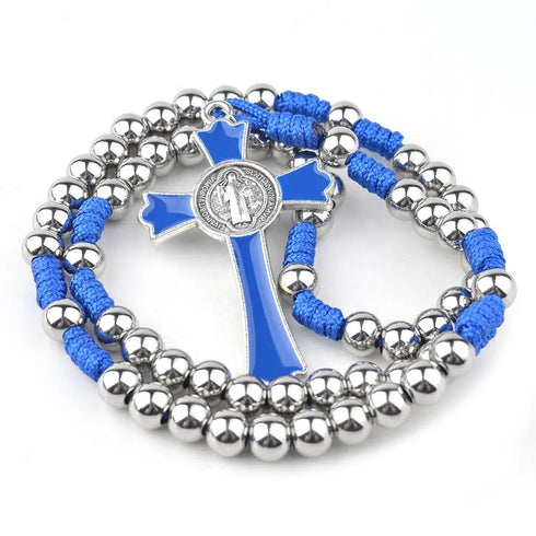 Stainless steel Saint Benedict rosary with blue paracord and crucifix on white surface.