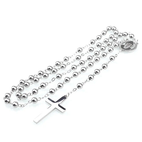 Rosary featuring stainless beads ,a cross and St. Charbel charm, shining under soft light.