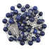 Lapis Lazurite Rosary with Virgin Mary centrepiece and antique silver-plated crucifix on white background.
