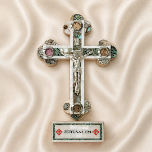 Decorative cross with Jerusalem label on a beige fabric background