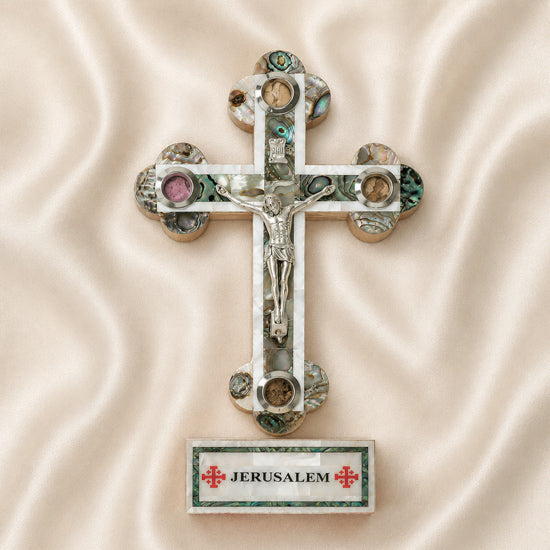 Decorative cross with Jerusalem label on a beige fabric background