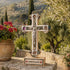 Decorative cross with 'Jerusalem' inscription on a stone surface with a scenic background.