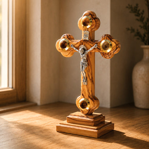 Standing wooden crucifix with Four Elements on a wooden table