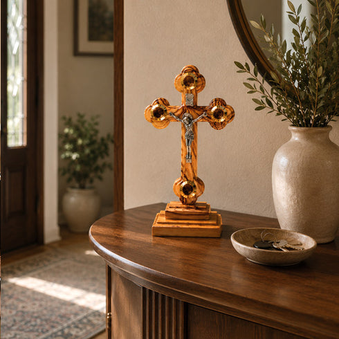 Standing wooden crucifix on a table near entrance door