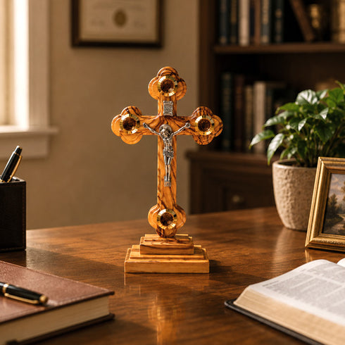 Altar olive wood crucifix with Four Elements on a home office table