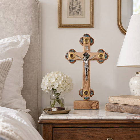 Olive wood Apostles crucifix hanging on a bedroom wall as part of a calm, traditional Christian home interior