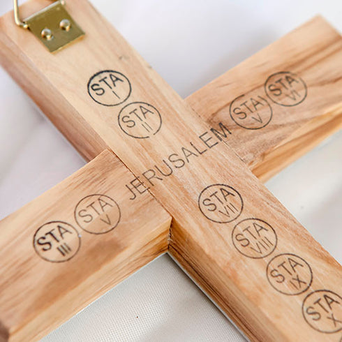 Back of an olive wood latin cross with print of the word "Jerusalem" and the station of cross with a hook to hand on the wall.